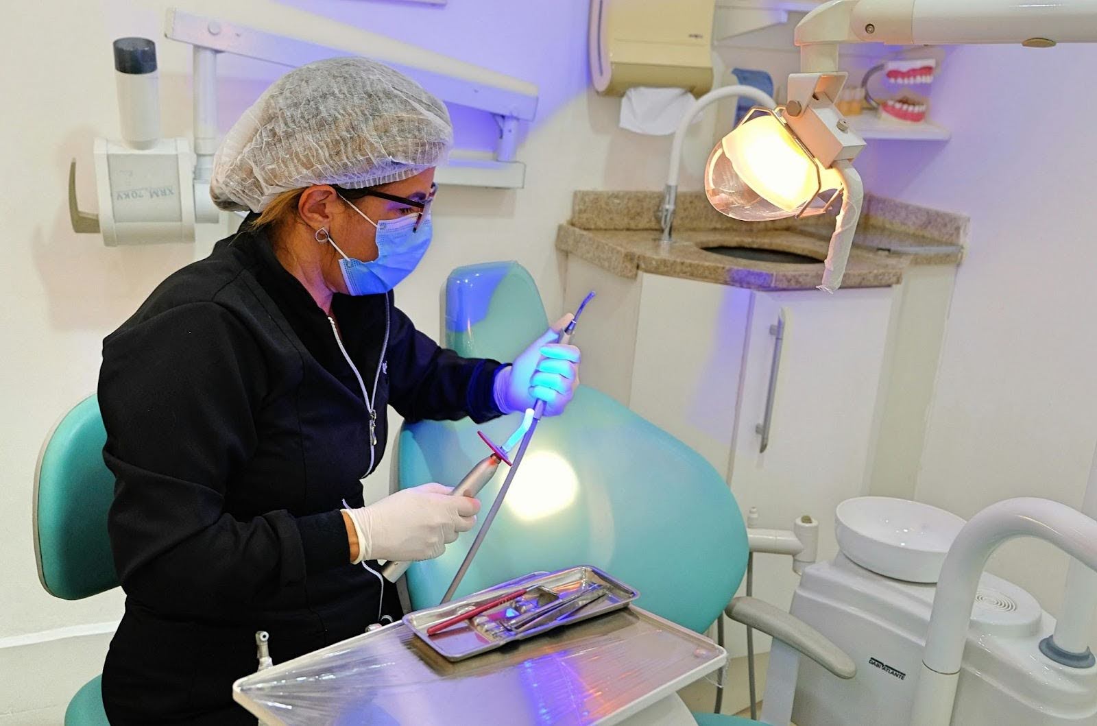 A dentist holding dental tools